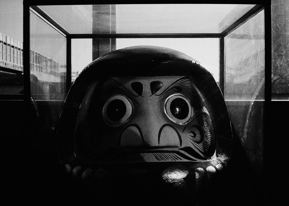Daruma in a glass case.